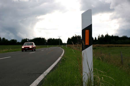 Dark road edges are clearly visible with reflector posts.