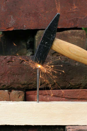 A heavy hammer blow makes the sparks fly.の写真素材
