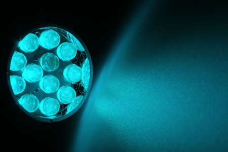 12 cyan LEDs shine on a surface.