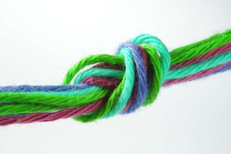 Eight colorful strips of wool are tied together.の写真素材