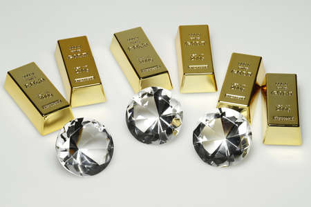 Gold bars and diamonds are together on the picture.の写真素材