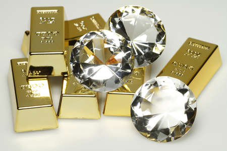 Gold bars and diamonds are together on the picture.の写真素材