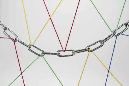 A chain is held by wool threads の写真素材