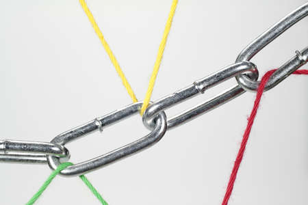 A chain is held by wool threads 