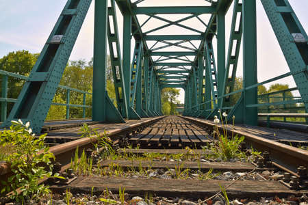 Old railway bridge with truss structure and bottom-mounted roadway の写真素材