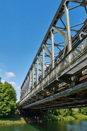 Old railway bridge with truss structure and bottom-mounted roadway の写真素材