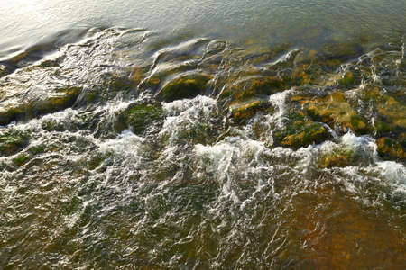 Rapid flowing water over rocks on a River の写真素材