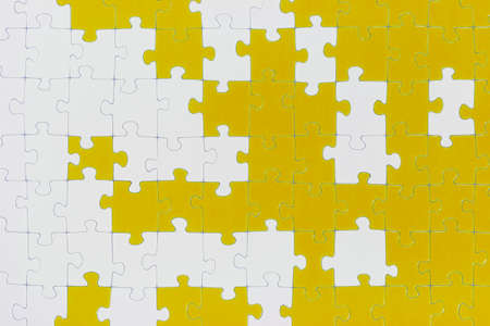 A puzzle is made up of puzzle pieces in two colors 
