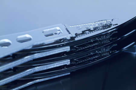 Close up of an opened hard disk with visible read head の写真素材