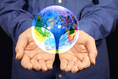 A magic globe hovering above two hands.の写真素材
