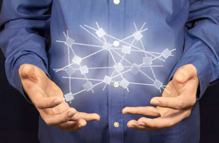A white network hovers above two hands.