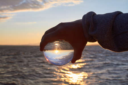 The sun sets over Lake Constance in Germany and lit by a crystal ball.の写真素材