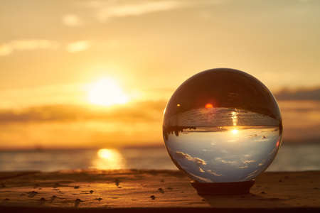 The sun sets over Lake Constance in Germany and lit by a crystal ball.の写真素材