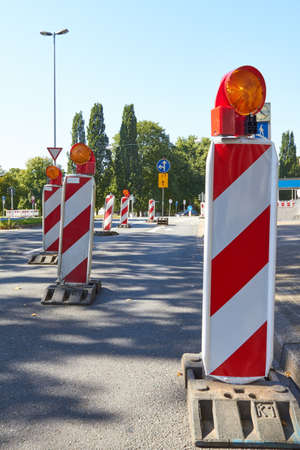 Warning beacons lock the lane on a road.