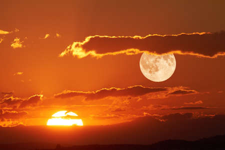The sun and the moon can be seen in the sky Simultaneously.の写真素材