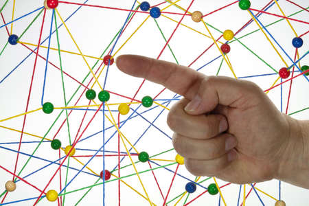 Colorful wool threads form a network between colorful balls.