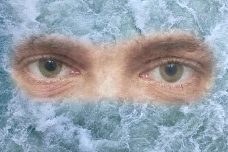 Eyes look up from vigorously bubbling water.の写真素材