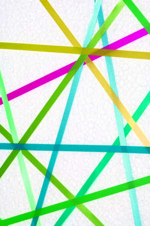 Colorful ribbons create a network on a white background.の写真素材