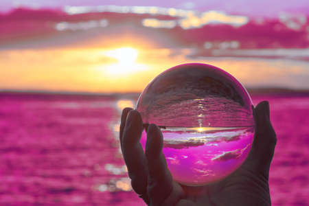 The sun sets over Lake Constance in Germany and lit by a crystal ball.の写真素材