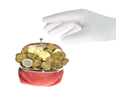 A hand in a white glove grabs a red purse.の写真素材