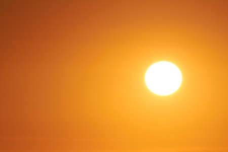 The sun can be seen in the cloudless sky.