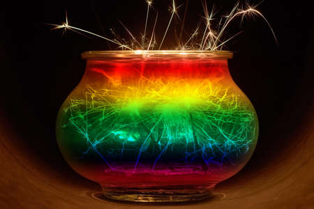 Brightly sparkling sparkles in a glass against a dark background.