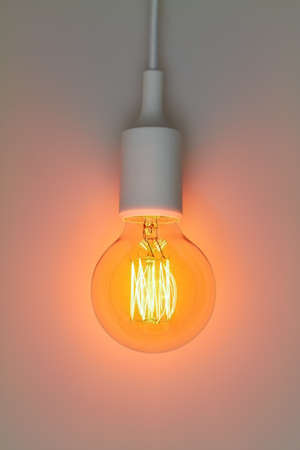 A bright lamp against a gray background.の写真素材