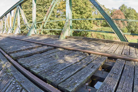 Old railway bridge with truss structure and bottom-mounted roadway.の写真素材