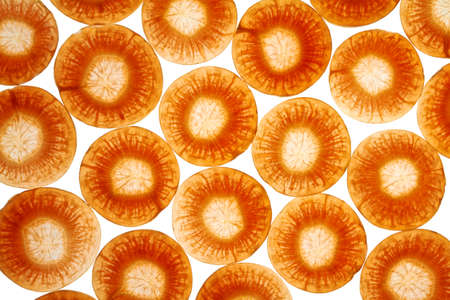 Side by side carrot slices are illuminated from below.の写真素材