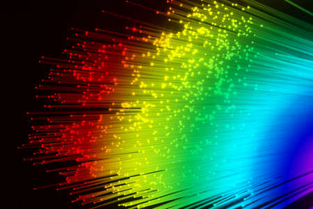 A bundle of optical fibers creates points of light in the dark.