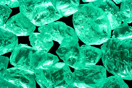 Several small glass pieces lie on top of each other close.