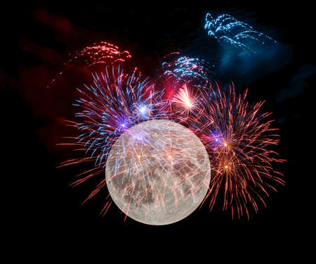 A great fireworks in the night before the full moon.の写真素材