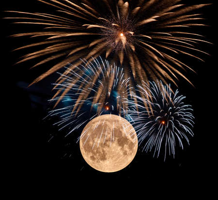 A great fireworks in the night before the full moon.の写真素材