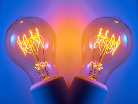 Old electric light bulb with orange luminous glow spiral.の写真素材