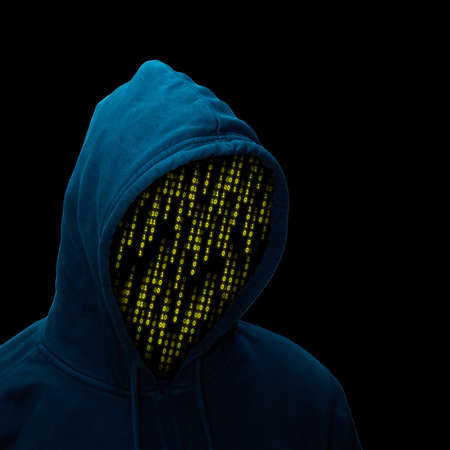 Dangerous hacker with hooded sweater against a black background.の写真素材