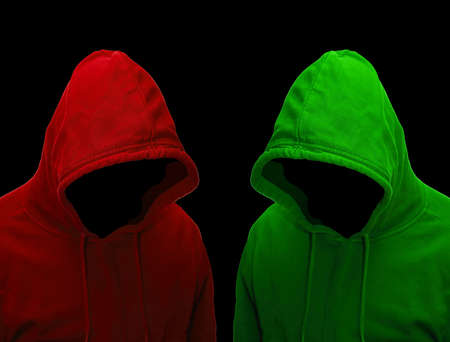 Dangerous hacker with hooded sweater against a black background.の写真素材