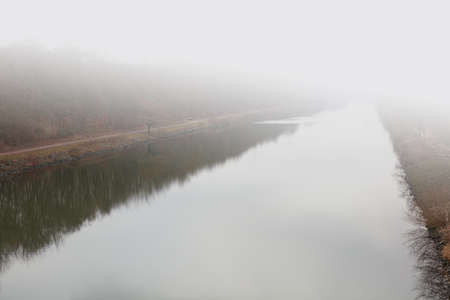 The banks of the Rhine-Herne Canal on a foggy winter day.の写真素材