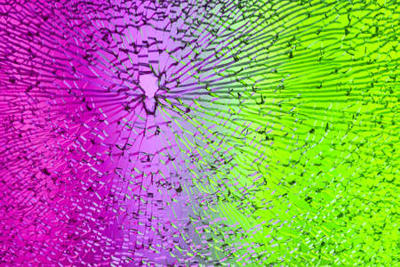 Colored light shines through a splintered glass.