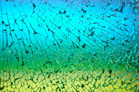 Colored light shines through a splintered glass.の写真素材