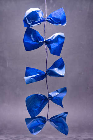 Colorful pieces of paper are tied on a ribbon and hang down.の写真素材