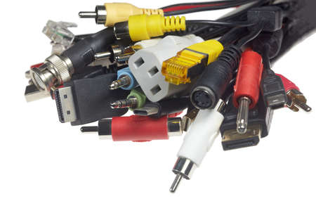 A bundle of different electrical plugs against a white background.の写真素材