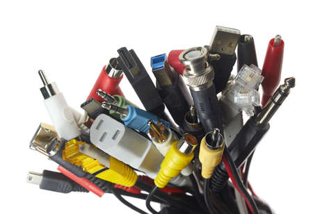 A bundle of different electrical plugs against a white background.
