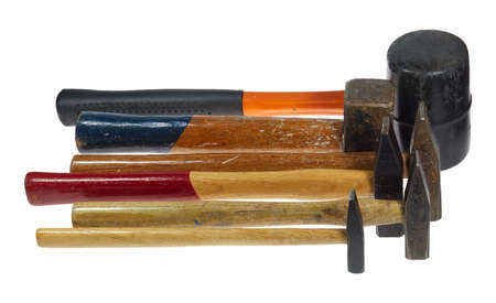 Several used hammers against a white background.