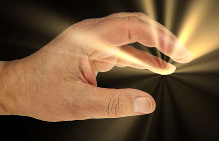 An open hand with rays of light against a black background.
