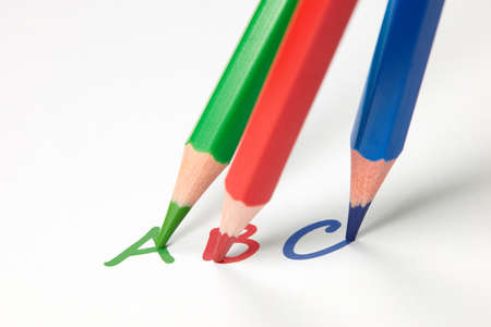 Three crayons write the letters ABC on paper.の写真素材