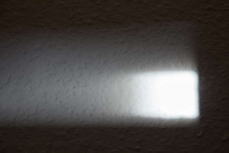 A wall that is brightly illuminated by the sun.