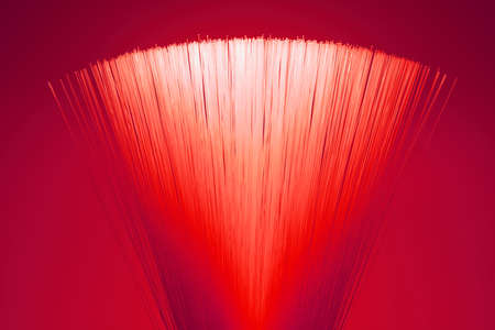 A bundle of optical fibers shines in the darkness.の写真素材