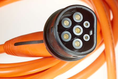 A colored charging cable for electric cars against a white background.