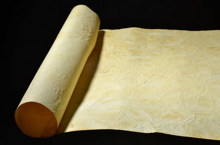 developed handmade sheet of old paper on a black backgroundの写真素材