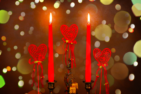 lighted candles with three heartsの写真素材